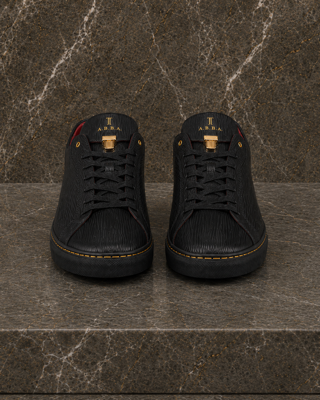 Front view of A.B.B.A. Low C.Y.B.N. black calfskin sneakers with gold details and red lining