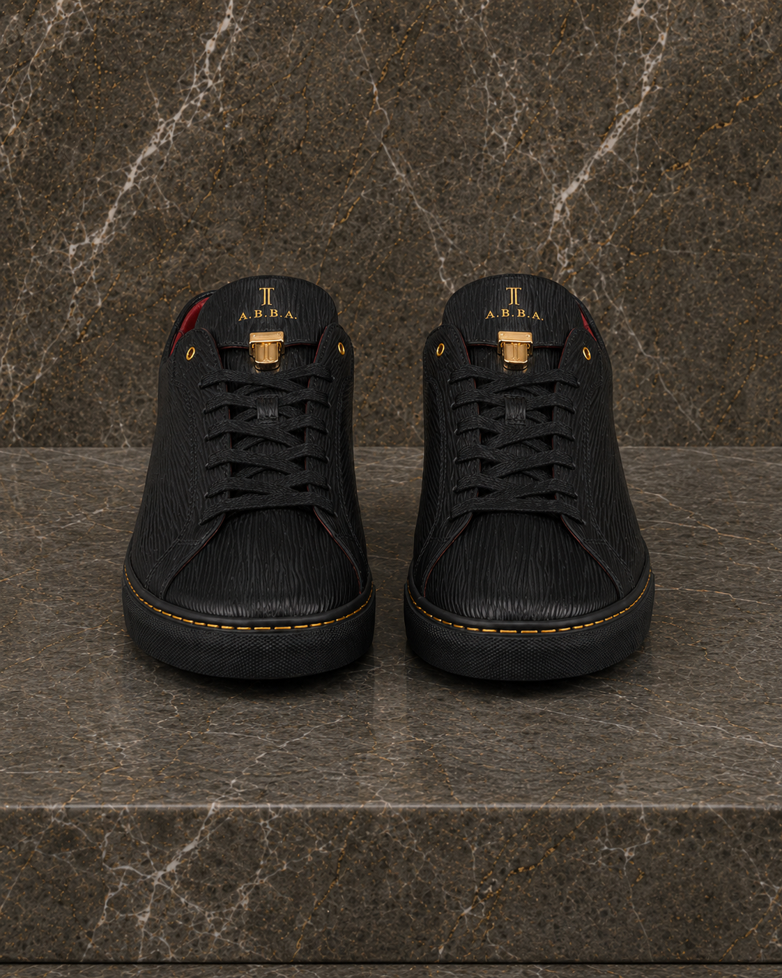 Front view of A.B.B.A. Low C.Y.B.N. black calfskin sneakers with gold details and red lining