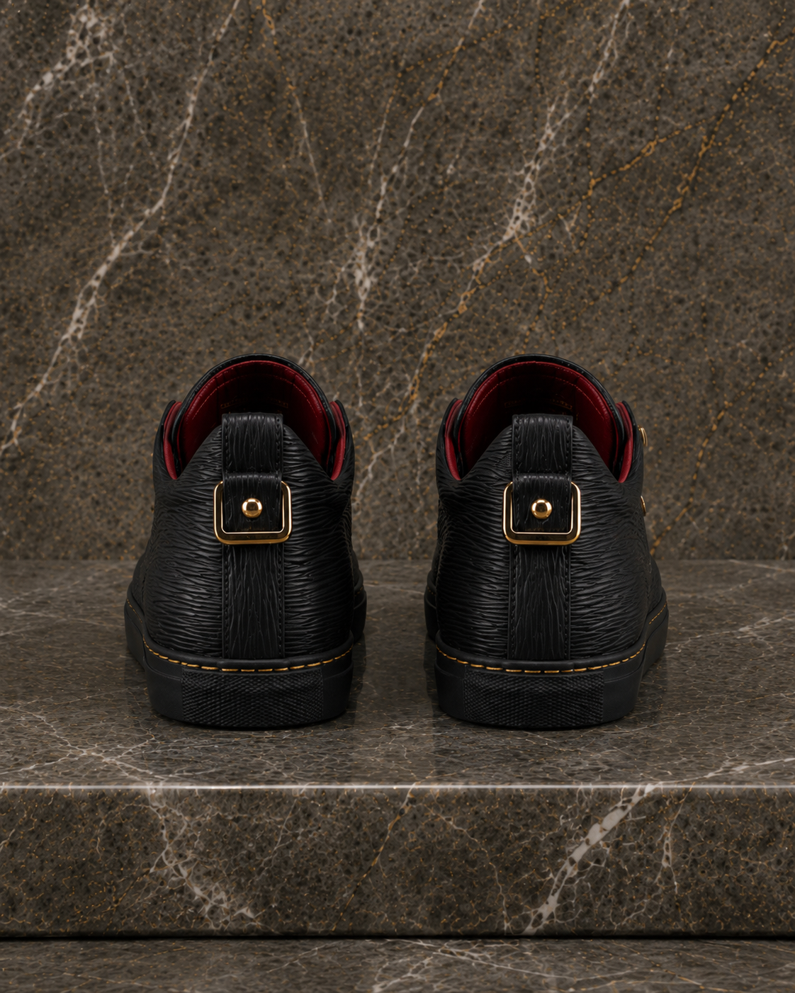 Rear view of A.B.B.A. Low C.Y.B.N. black calfskin sneaker with gold details and red lining